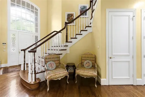 a view of entryway and hall with wooden floor