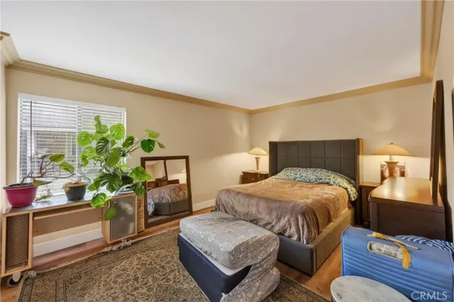 a bedroom with a bed dresser and a chair