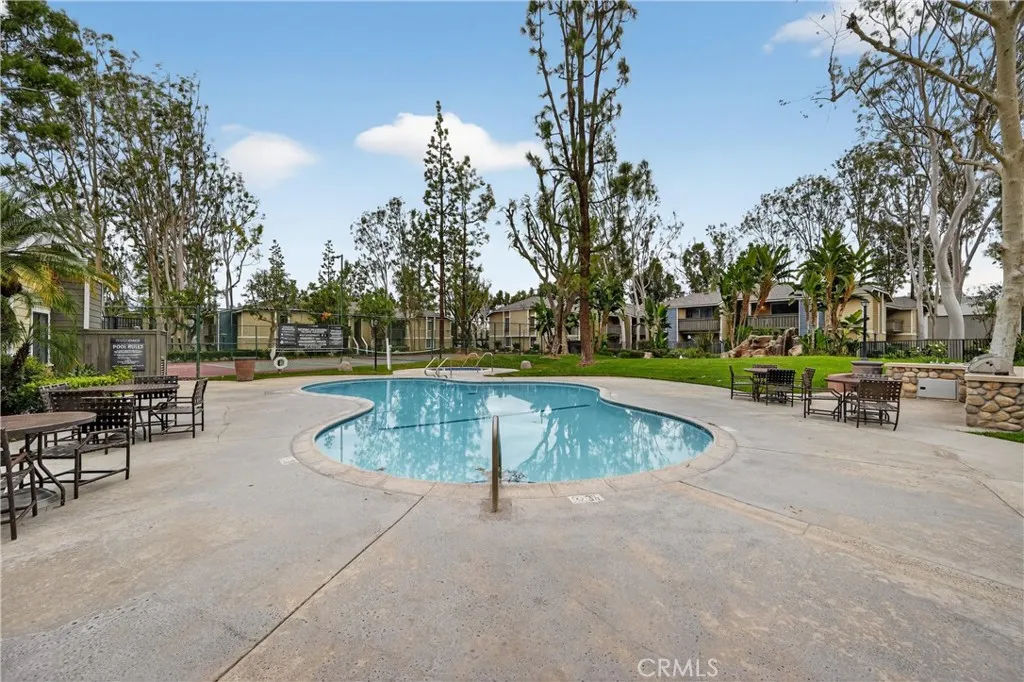 3535 Banbury Drive, Unit 94 Riverside, CA 92503 - Photo 16 of 21 a view of a swimming pool with lawn chairs and a fire pit