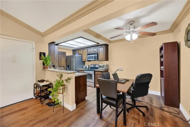 a view of a dining room with furniture and a chandelier