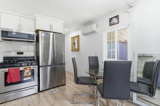 a kitchen with stainless steel appliances granite countertop a refrigerator and a stove top oven