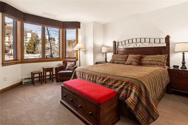 a bedroom with a bed and a table chair