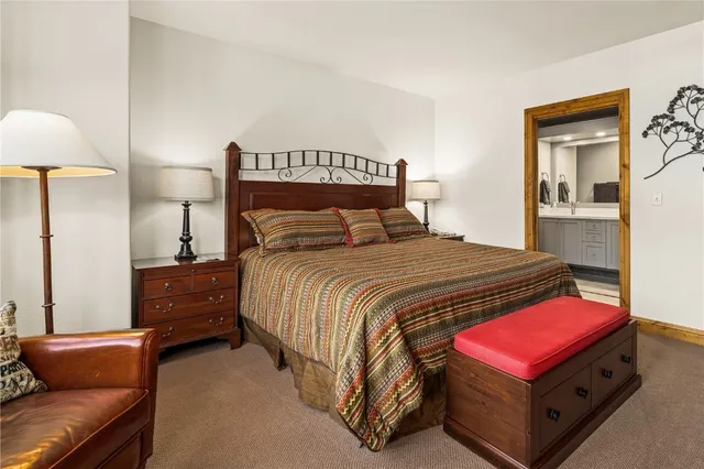 a bedroom with a bed and lamp