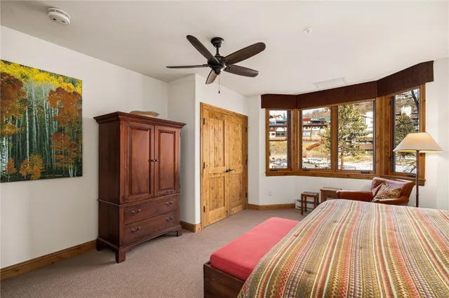 a bed room with a bed and a large window