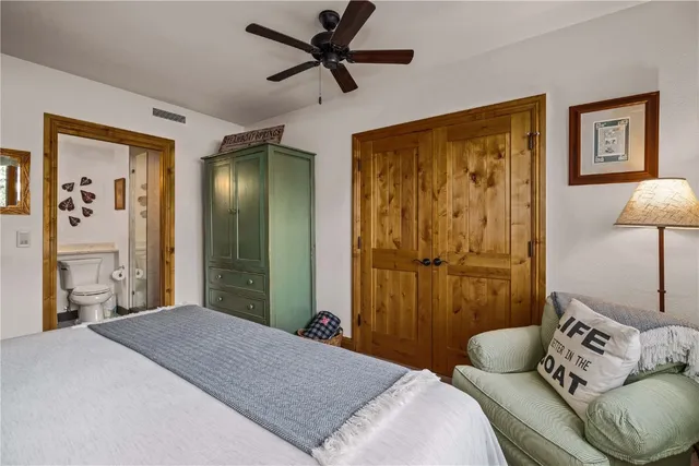 a bedroom with a large bed and a chandelier