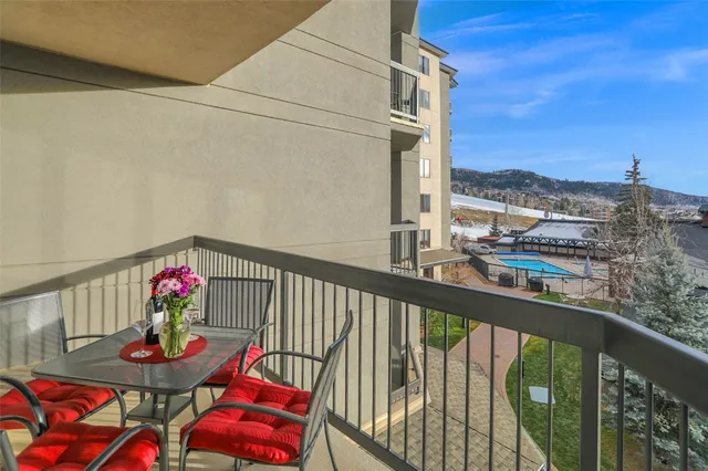 a city view from a balcony with outdoor seating