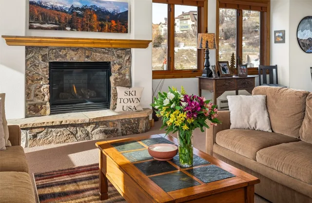 a living room with furniture and a fireplace