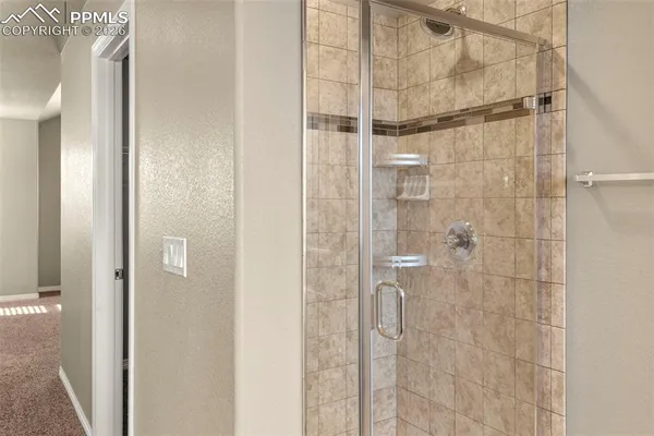 a bathroom with a glass shower door