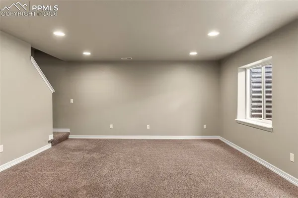 an empty room with windows and closet