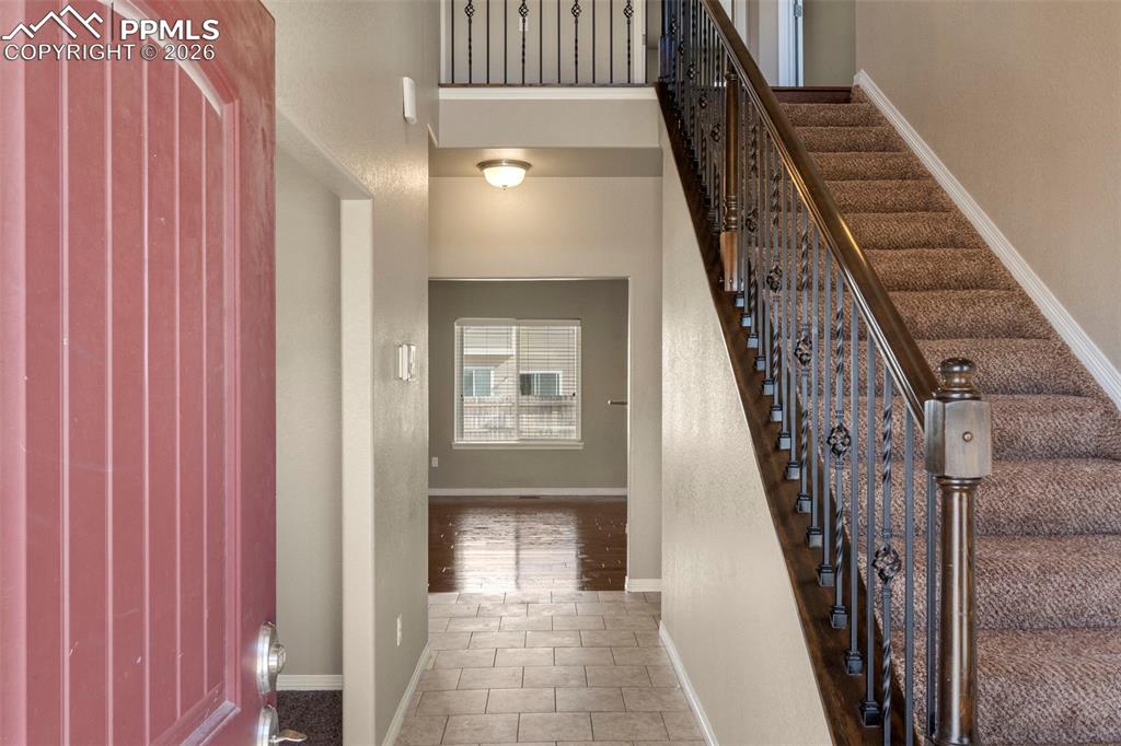 6105 Fiddle Way Colorado Springs, CO 80925 - Photo 4 of 40 a view of an entryway with staircase