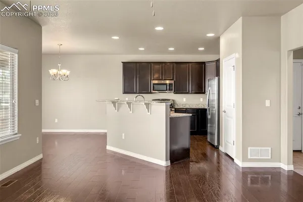 a view of a kitchen with a sink and a refrigerator