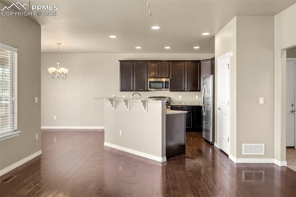 6105 Fiddle Way Colorado Springs, CO 80925 - Photo 6 of 40 a view of a kitchen with a sink and a refrigerator