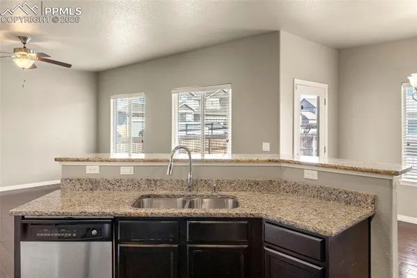 a kitchen with granite countertop a sink and a window