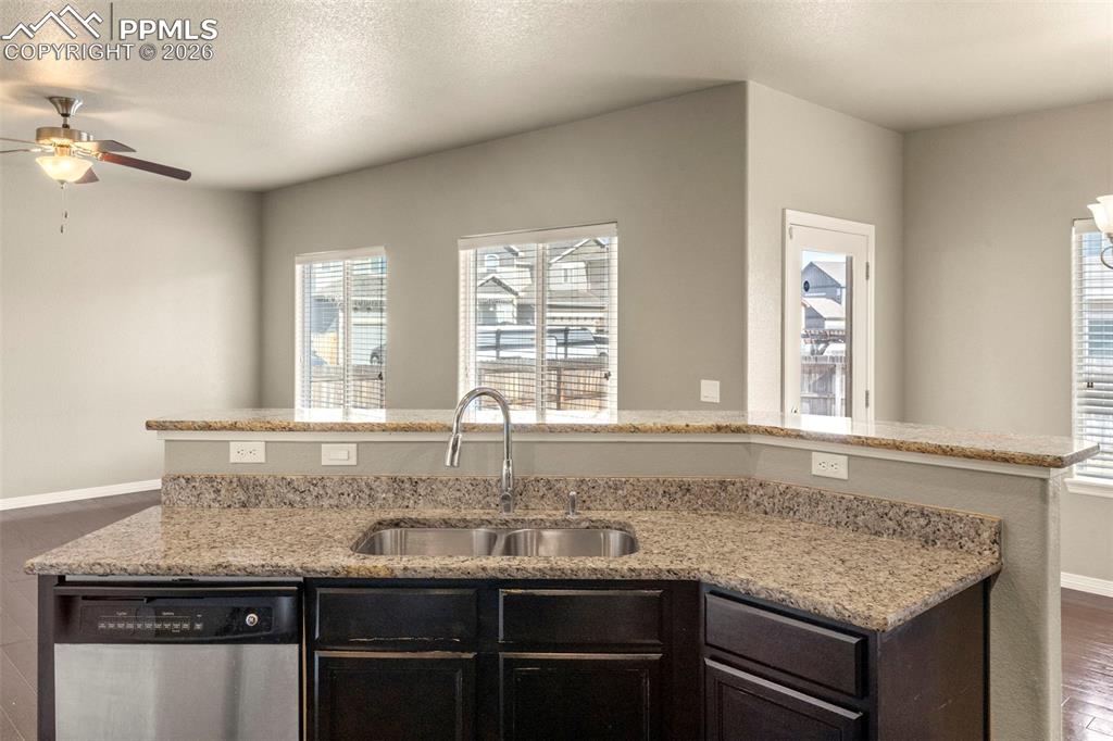 6105 Fiddle Way Colorado Springs, CO 80925 - Photo 10 of 40 a kitchen with granite countertop a sink and a window