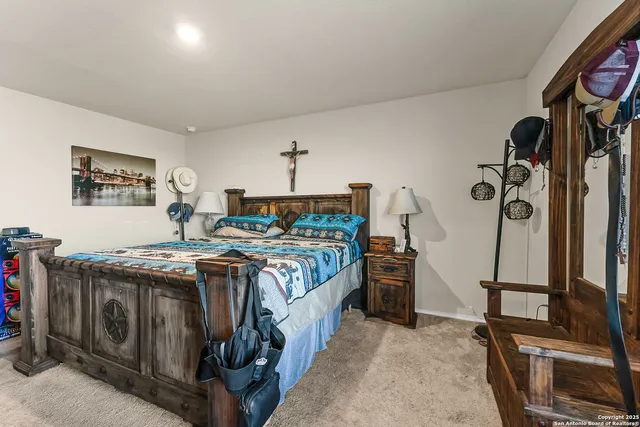 a bedroom with a bed and a flat tv screen on the dresser