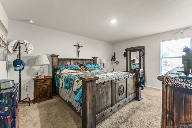 a spacious bedroom with a bed and a chandelier
