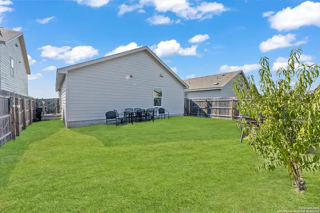 a backyard of a house with lots of green space