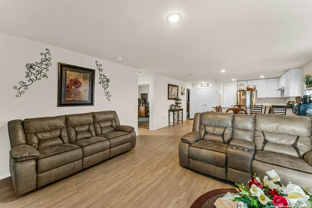 a living room with furniture kitchen and a couch