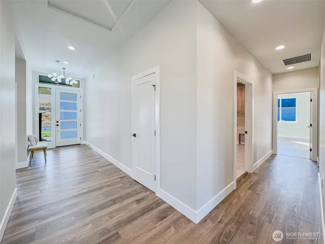 a kitchen with a sink stainless steel appliances and white cabinets