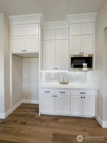 a bathroom with a tub sink double vanity and mirror