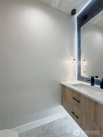 a bathroom with double vanity and a mirror