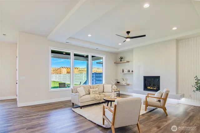 a living room with furniture a fireplace and a flat screen tv