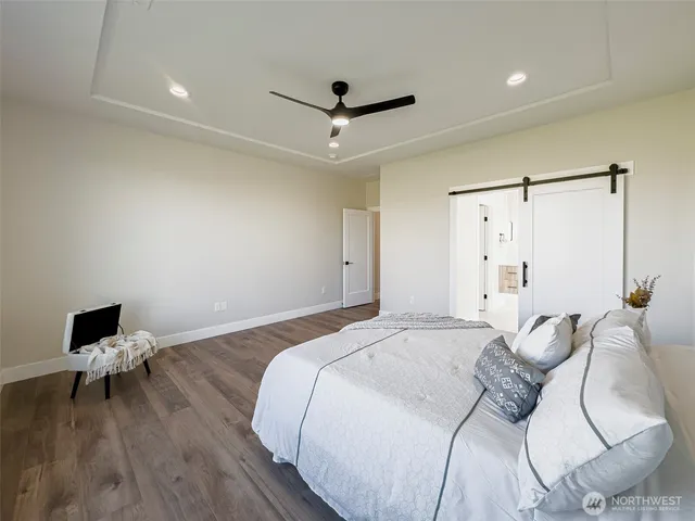 a bedroom with a bed and a ceiling fan