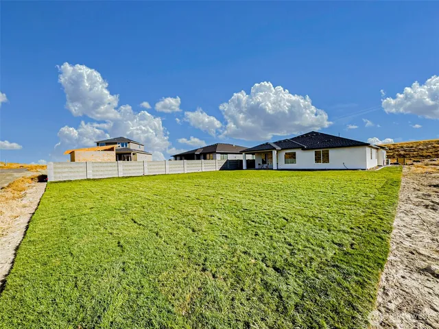 a view of a room with wooden floor table and chairs