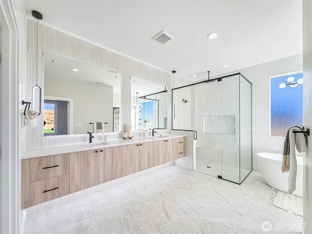 a large white bathroom with a granite countertop sink mirror and a shower