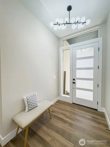 a large kitchen with lots of counter space and a wooden floor