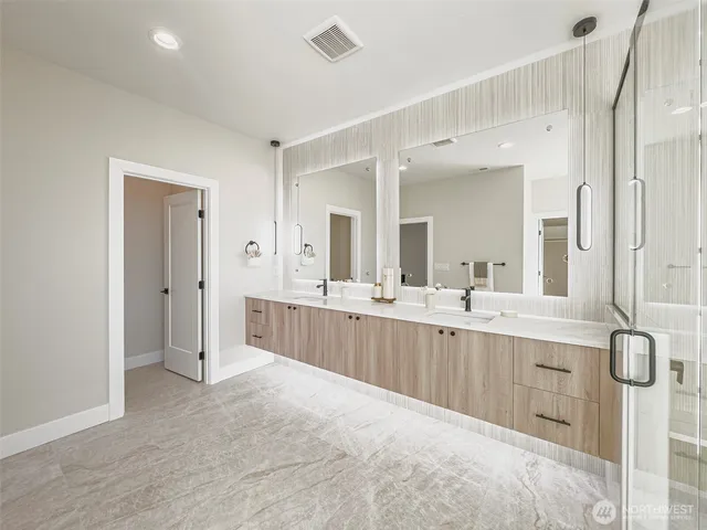 a large bathroom with a double vanity sink mirror and double