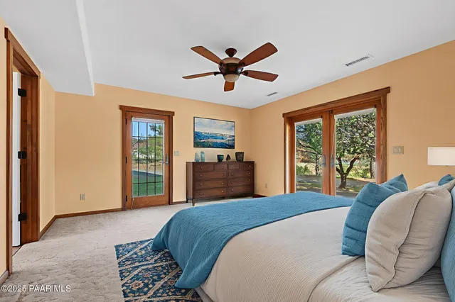 a bathroom with a granite countertop double vanity and a mirror