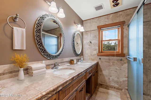a spacious bathroom with a double vanity sink double and mirror