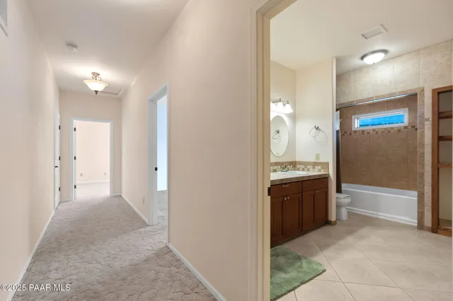 a bedroom with a bed a dresser and window