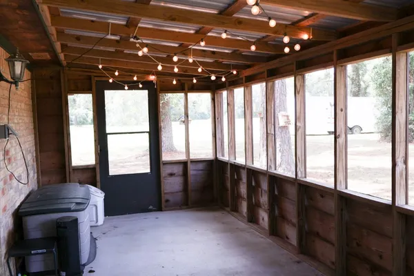 a aerial view of a house next to a big yard with large trees