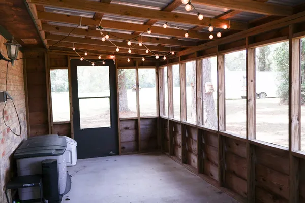 a aerial view of a house next to a big yard with large trees