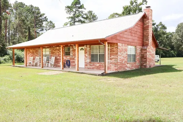 a view of a dining room with furniture and a window