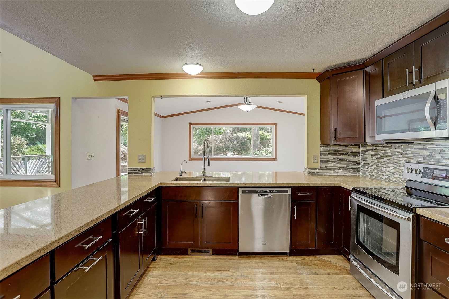 18600 East Spring Lake Drive Southeast Renton, WA 98058 - Photo 16 of 39 a kitchen with a sink stove and cabinets