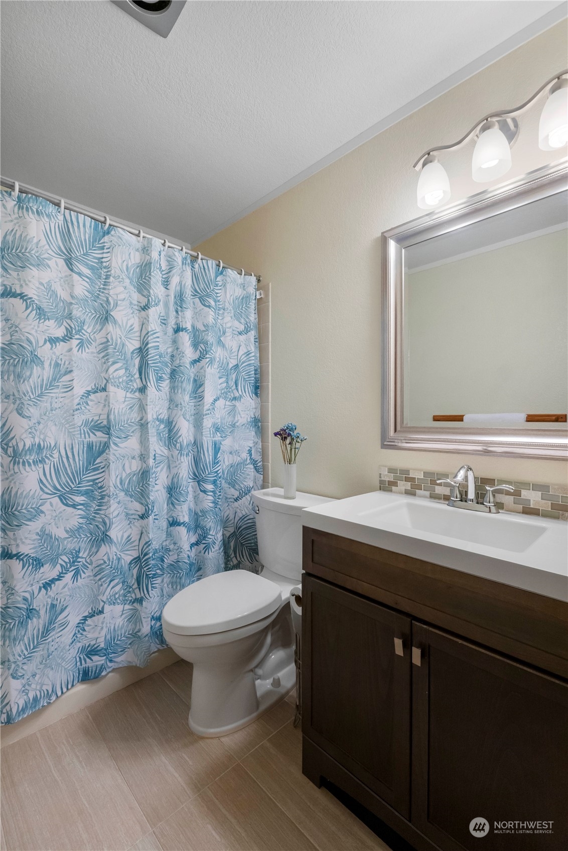 18600 East Spring Lake Drive Southeast Renton, WA 98058 - Photo 8 of 39 a bathroom with a granite countertop sink a toilet and a mirror