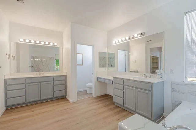 a spacious bathroom with a granite countertop sink mirror and a