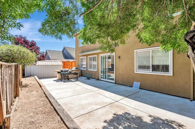 a view of backyard with a patio