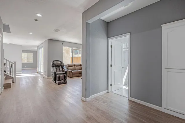 a view of a livingroom with a flat screen tv and couches with wooden floor