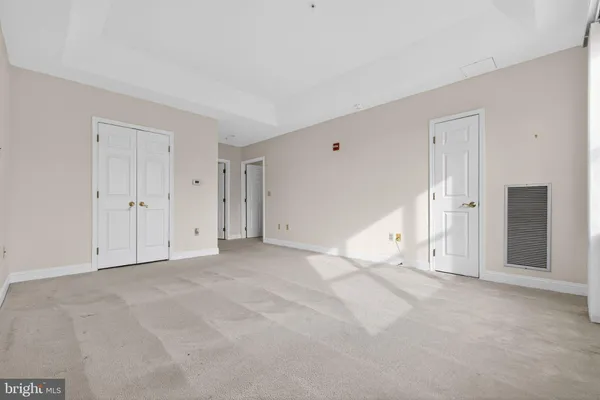 a view of walk in closet with empty racks