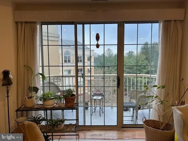 a view of a living room with furniture and window