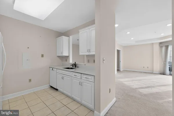 a view of a kitchen with white cabinets