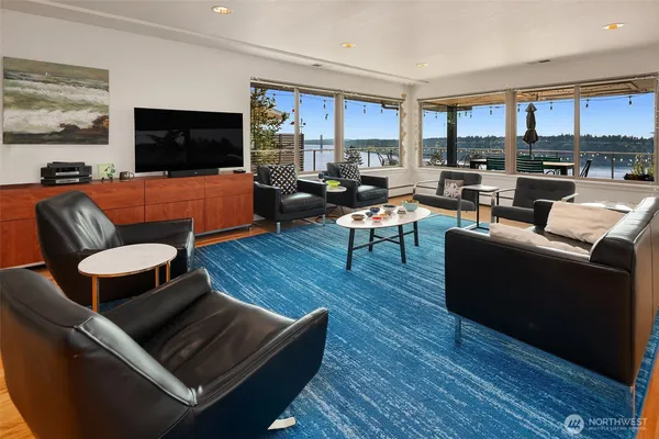 a living room with furniture kitchen view and a flat screen tv