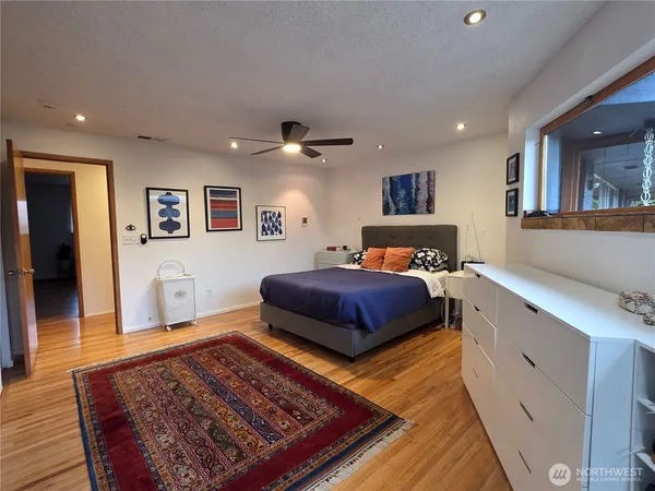 a bedroom with a large bed and a chandelier