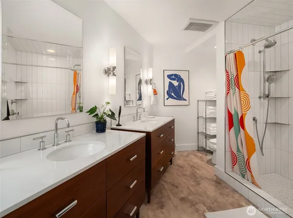 a spacious bathroom with a sink double vanity and a tub