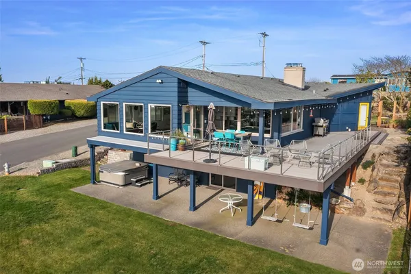 a backyard of a house with table and chairs