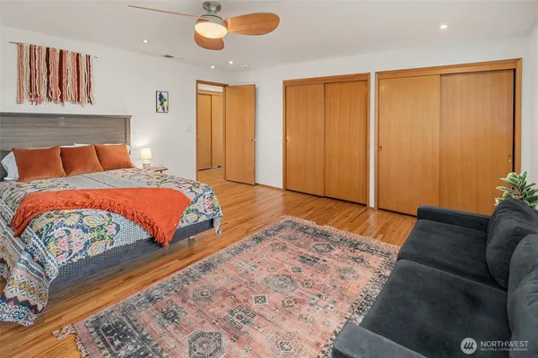 a bedroom with furniture and a rug